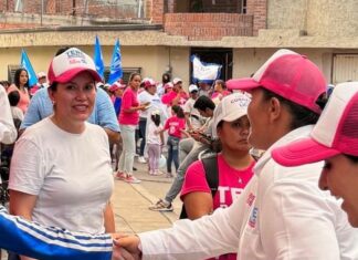 Tere Botello apoyada por Alejandrina Lanuza reparten tarjetas rosas de cartón para condicionar el voto este 2 de junio